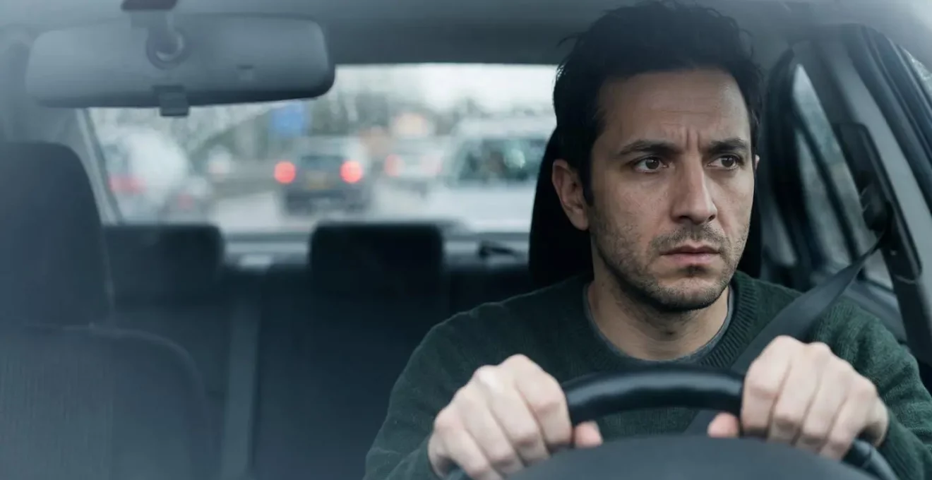 Portrait serré d'un conducteur concentré avec expression de tension illustrant le stress du harcèlement routier